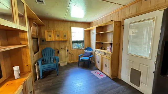 a room with wooden floors and windows