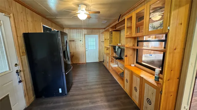 a view of a hallway with wooden shelves