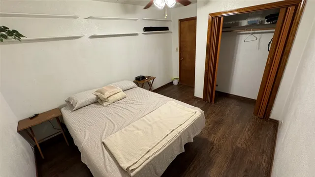 a bedroom with a bed and a mirror