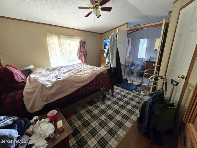 a bed sitting in a bedroom next to a window