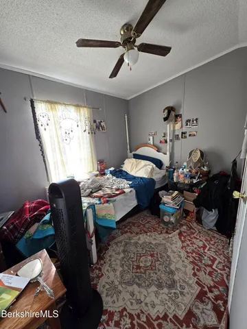 a bedroom that has a bed and a table in it