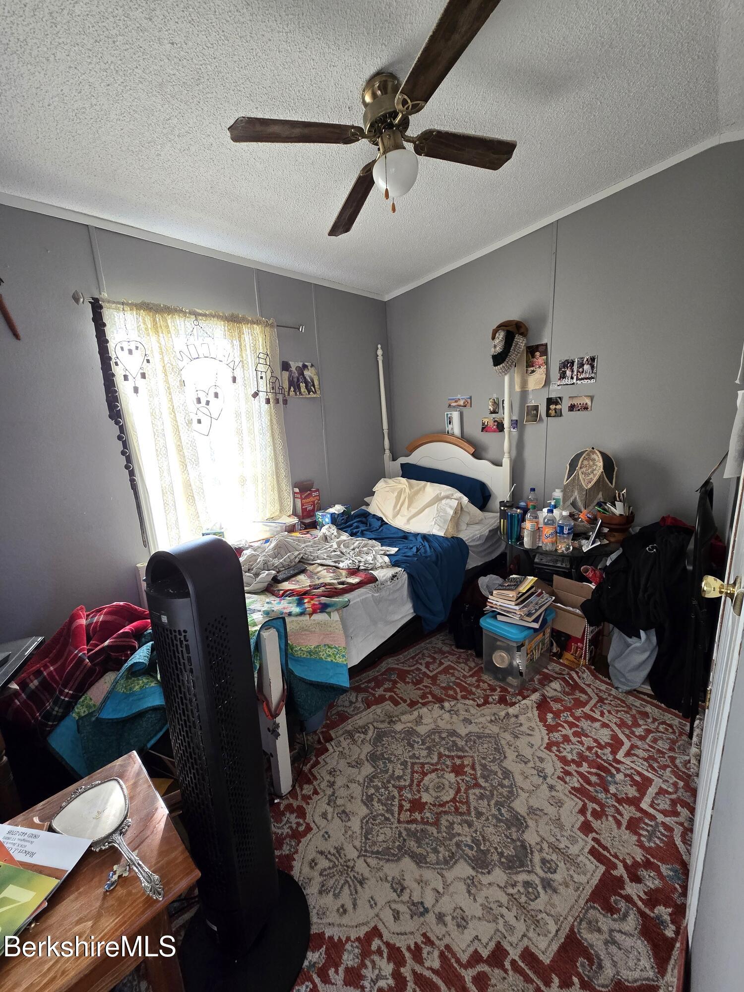 108 Baker Drive Bennington, VT 05201 - Photo 15 of 17 a bedroom that has a bed and a table in it