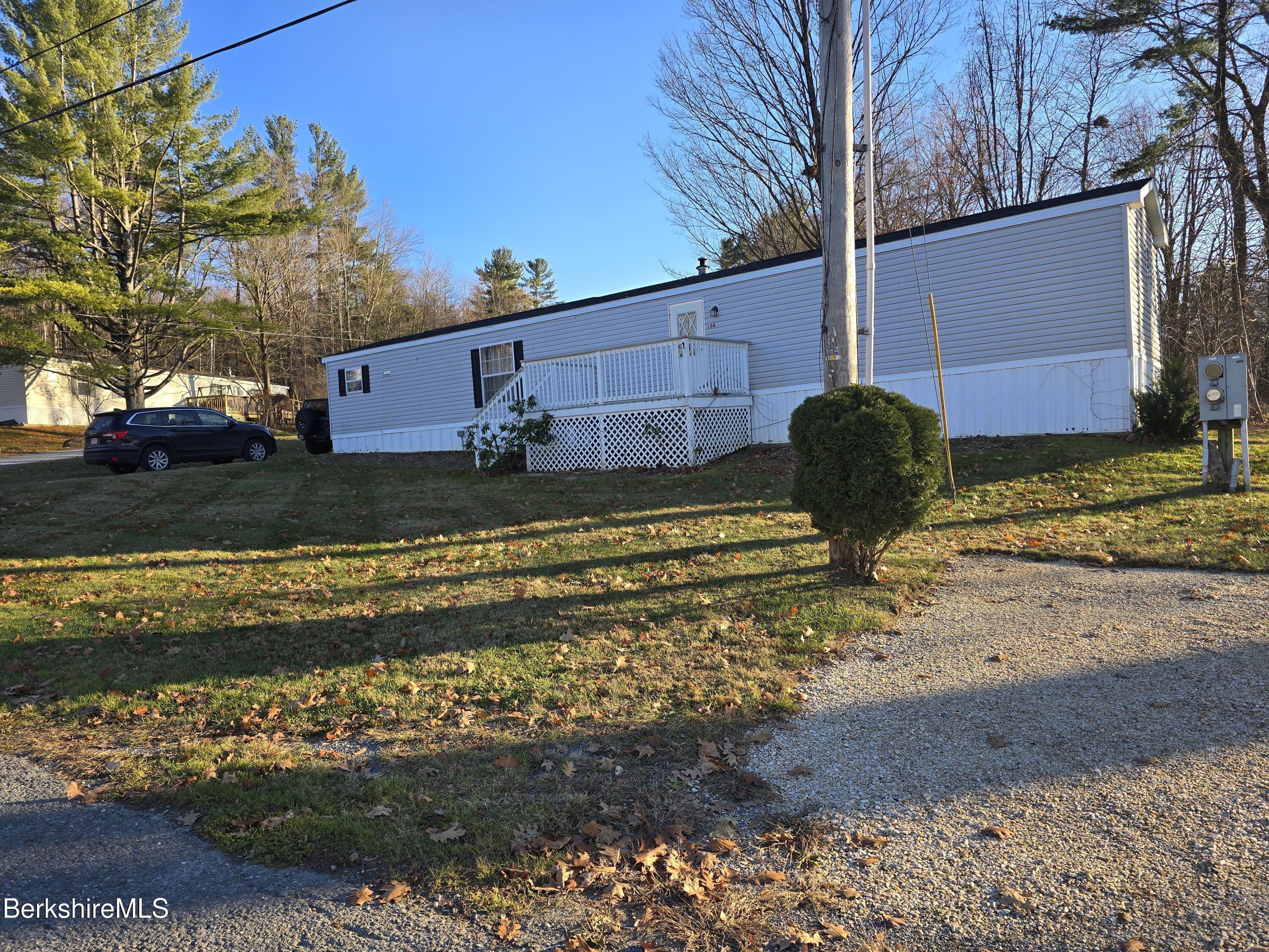 108 Baker Drive Bennington, VT 05201 - Photo 2 of 17 a view of a yard with an house and wooden fence