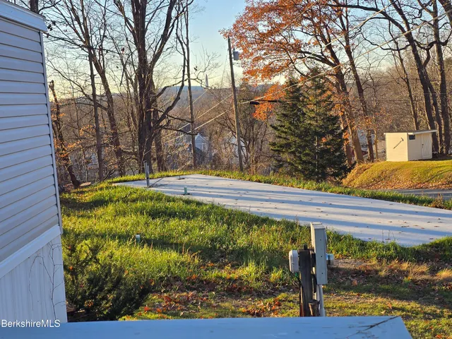 a view of backyard with wooden fence