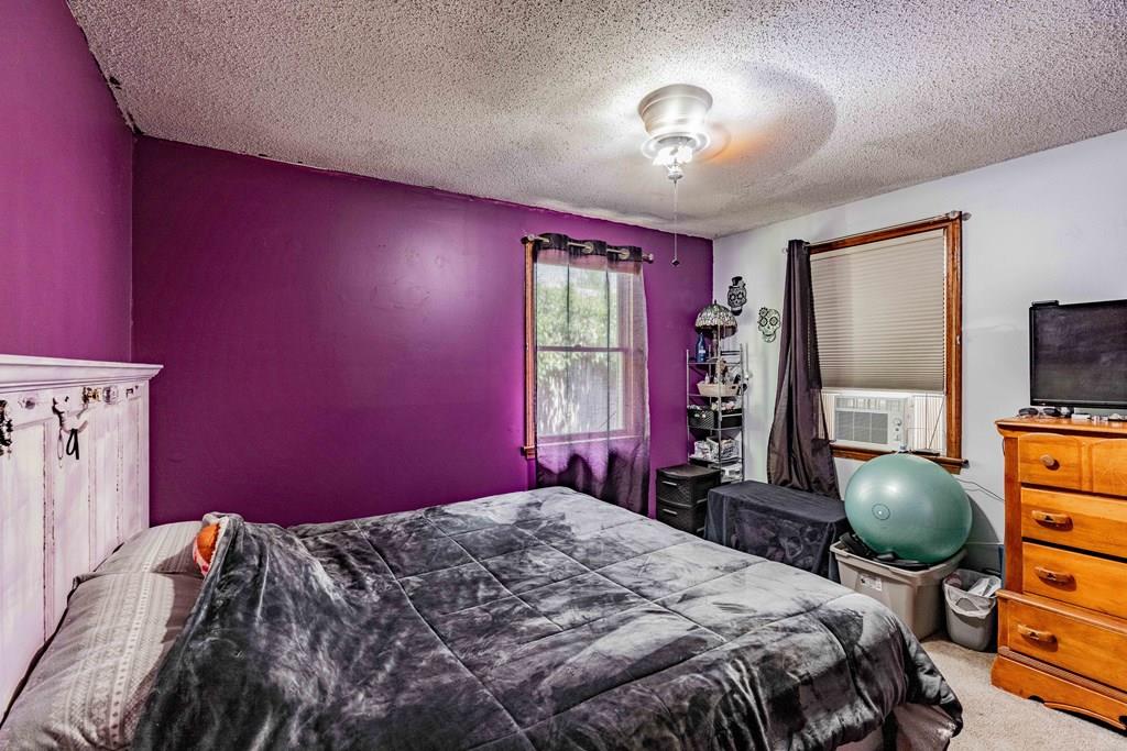 71 Ann Street Chicopee, MA 01020 - Photo 11 of 16 a bedroom with a bed dresser and a window