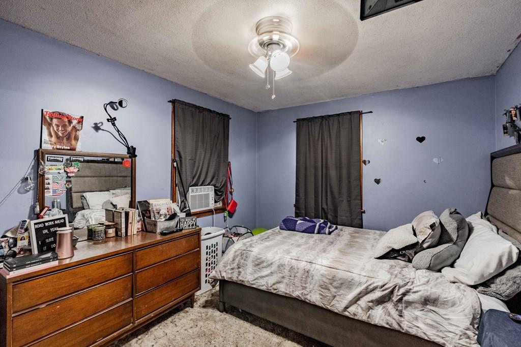 71 Ann Street Chicopee, MA 01020 - Photo 12 of 16 a bedroom with a bed and a chandelier