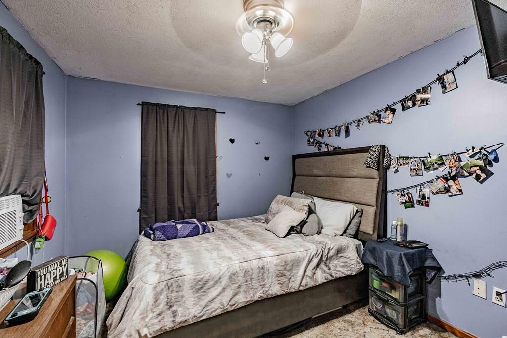 71 Ann Street Chicopee, MA 01020 - Photo 13 of 16 a bedroom with a bed and a chandelier