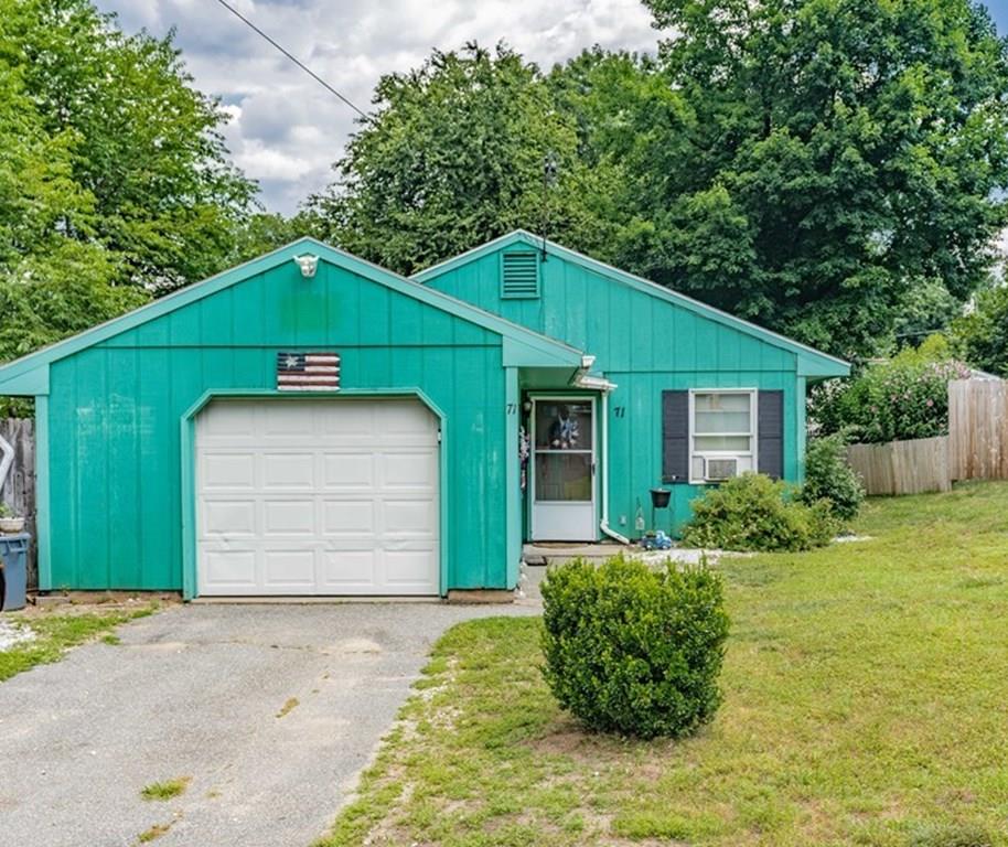 71 Ann Street Chicopee, MA 01020 - Photo 16 of 16 a front view of a house with a yard and garage