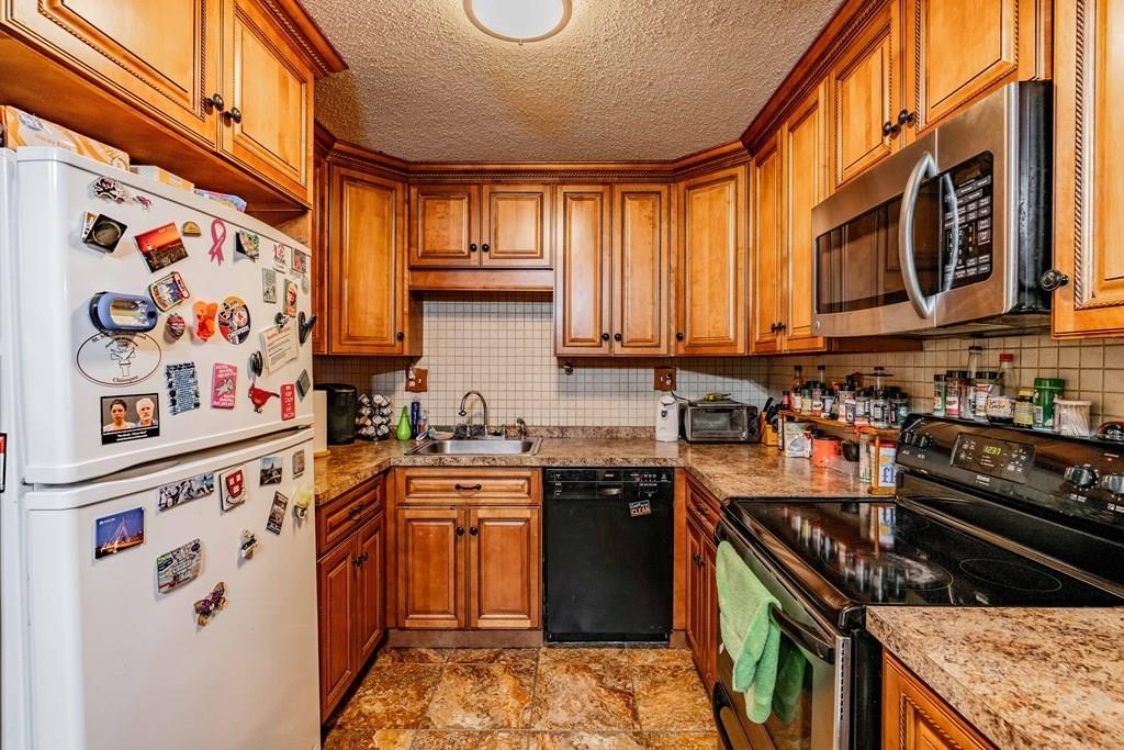 71 Ann Street Chicopee, MA 01020 - Photo 3 of 16 a kitchen with stainless steel appliances granite countertop a stove and a sink
