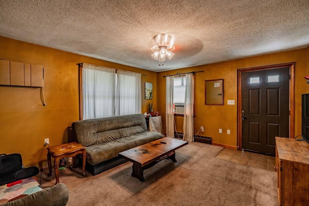 71 Ann Street Chicopee, MA 01020 - Photo 8 of 16 a living room with furniture and a chandelier