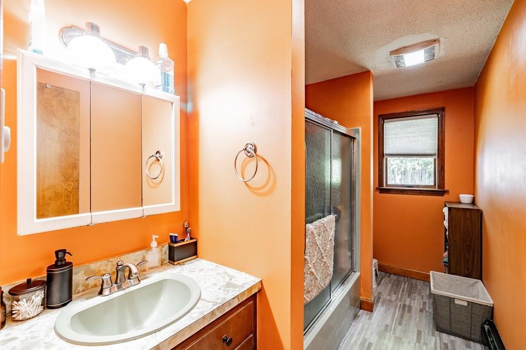 71 Ann Street Chicopee, MA 01020 - Photo 10 of 16 a bathroom with a sink a mirror and a shower