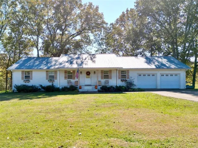 a front view of a house with swimming pool having outdoor seating