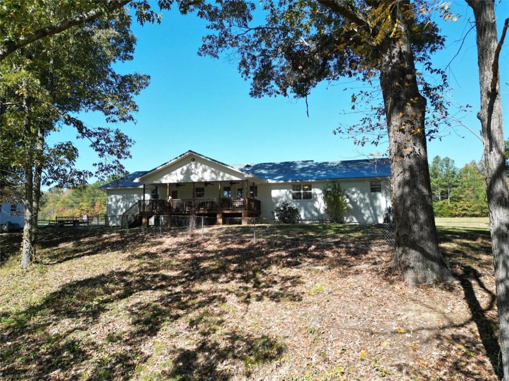2053 Buttermilk Road Southwest Cave Spring, GA 30124 - Photo 11 of 69 a view of a house with a yard tree and wooden fence