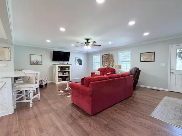 a view of a dining room with furniture wooden floor and chandelier
