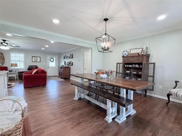 a large white kitchen with kitchen island a sink dishwasher a refrigerator and cabinets