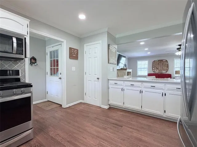 a kitchen with stainless steel appliances a refrigerator sink and cabinets
