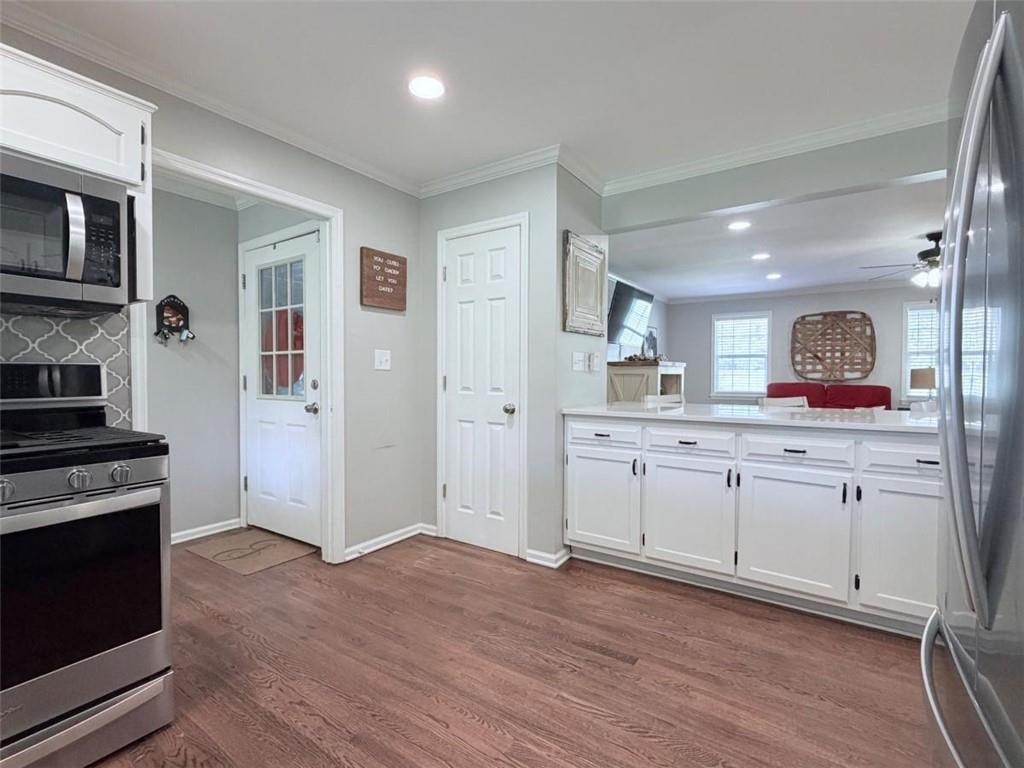 2053 Buttermilk Road Southwest Cave Spring, GA 30124 - Photo 27 of 50 a kitchen with granite countertop cabinets stainless steel appliances and a wooden floor