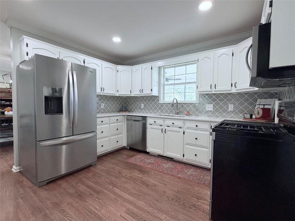 2053 Buttermilk Road Southwest Cave Spring, GA 30124 - Photo 27 of 69 a kitchen with white cabinets and stainless steel appliances