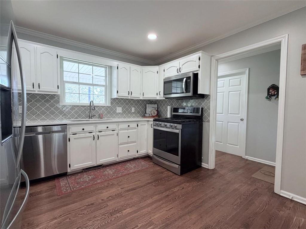 2053 Buttermilk Road Southwest Cave Spring, GA 30124 - Photo 30 of 69 a kitchen with stainless steel appliances granite countertop a stove a sink and a microwave