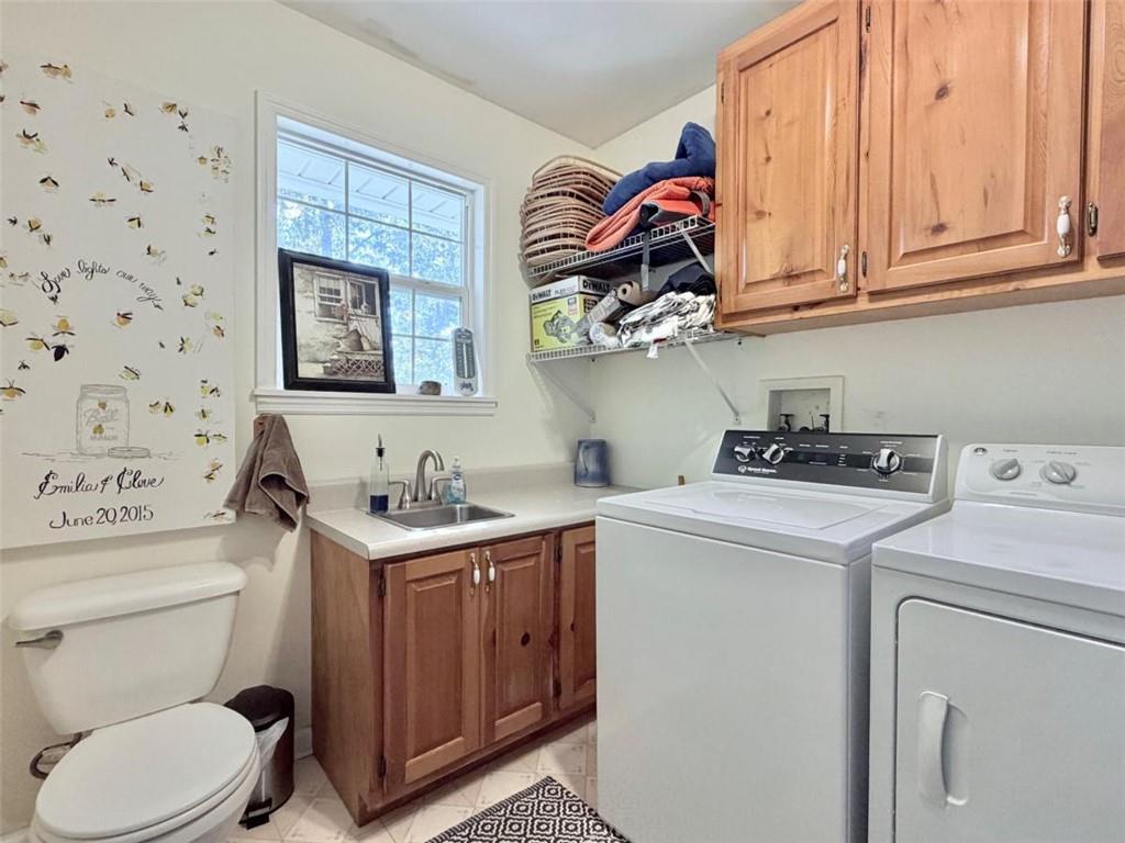 2053 Buttermilk Road Southwest Cave Spring, GA 30124 - Photo 31 of 50 a bathroom with a sink a toilet and a shower curtain