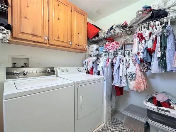a bedroom with a bed and a flat tv screen on dresser