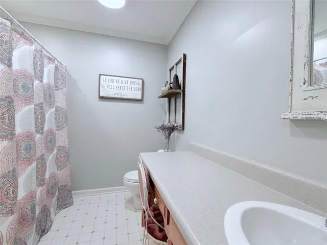 a bathroom with a sink a mirror and a shower