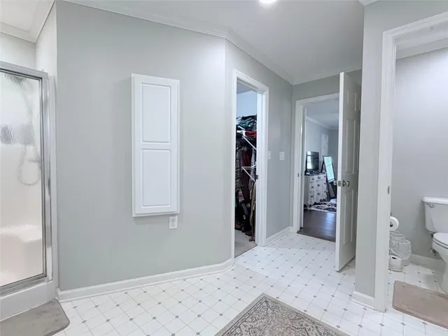 a spacious bathroom with a tub sink and mirror