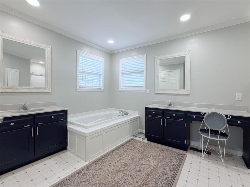 2053 Buttermilk Road Southwest Cave Spring, GA 30124 - Photo 48 of 69 a spacious bathroom with a tub sink and mirror