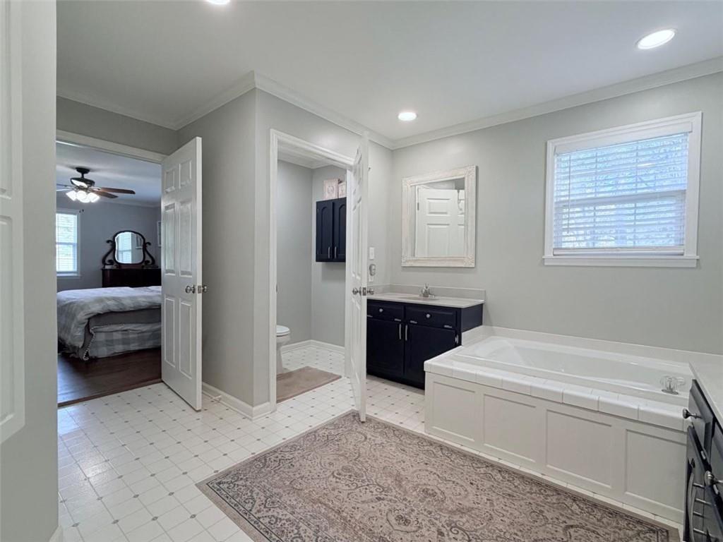 2053 Buttermilk Road Southwest Cave Spring, GA 30124 - Photo 50 of 69 a en suite bathroom with a granite countertop tub and a sink