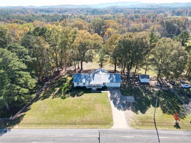 an aerial view of a house with a yard