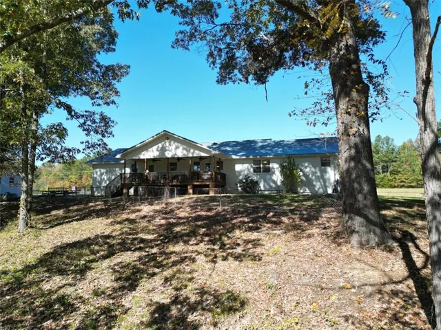 a view of a chairs and table in a backyard