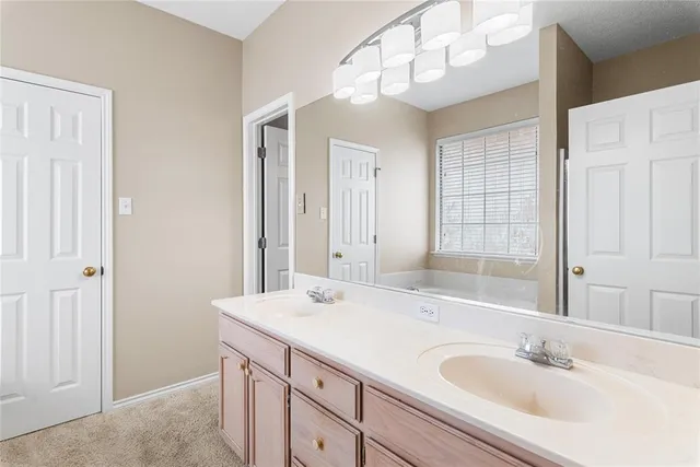a bathroom with a sink a vanity and a mirror