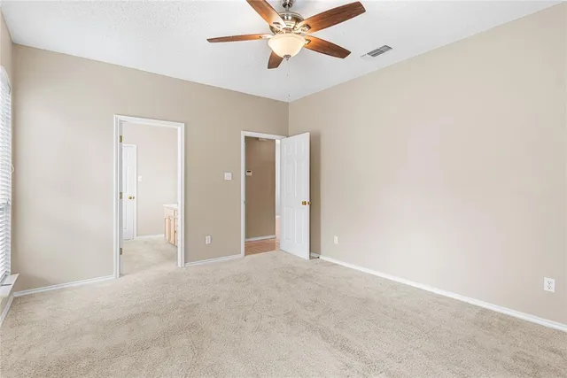 a view of a big room with a ceiling fan and a chandelier fan