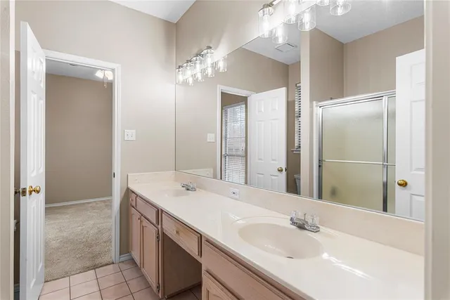 a bathroom with a sink double vanity and a mirror