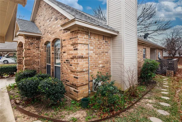 a front view of a house with plants