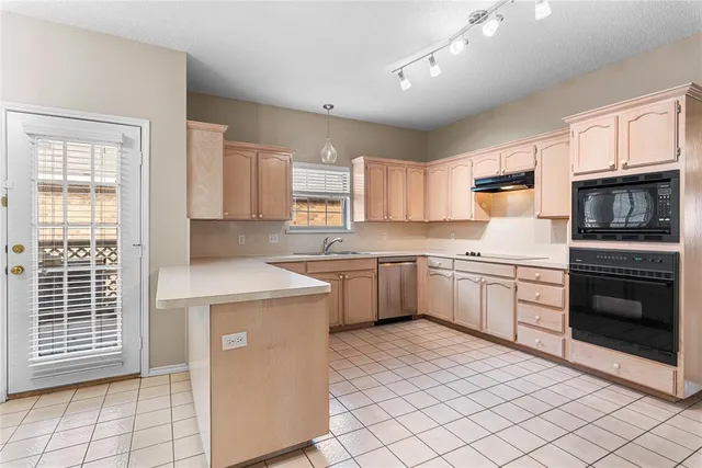 a kitchen with a stove a sink and a microwave