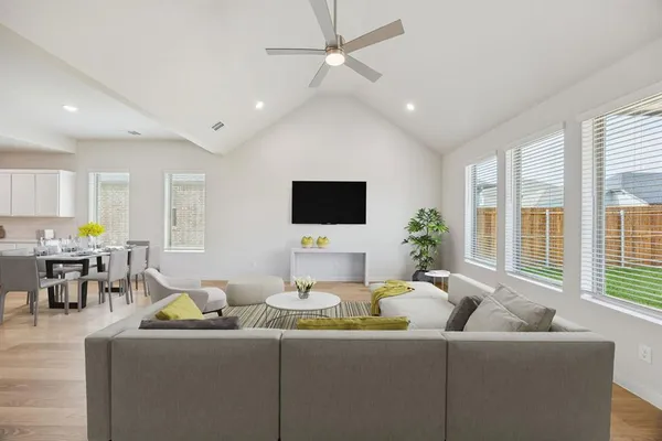 a living room with furniture and a flat screen tv