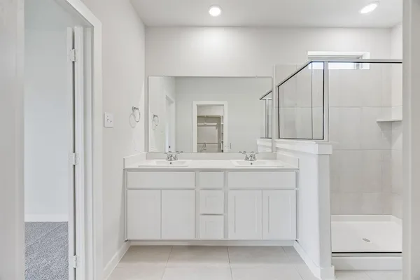 a bathroom with a double vanity sink and a mirror
