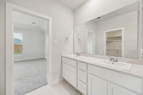 a bathroom with a double vanity sink mirror and