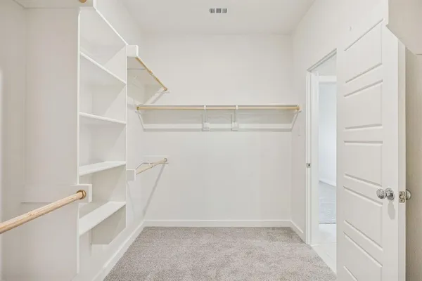 a view of an empty walk in closet