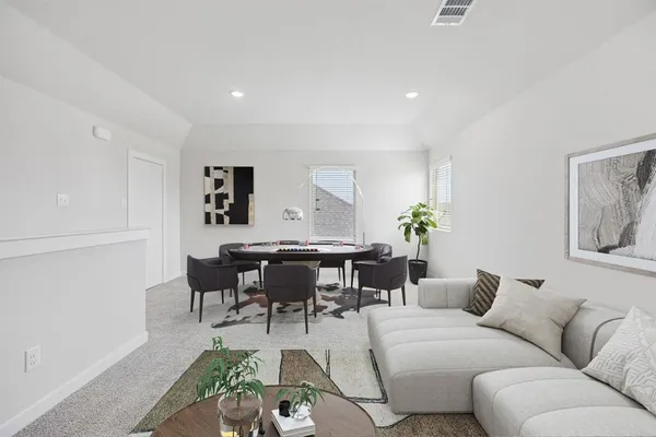 a living room with furniture a dining table and a potted plant