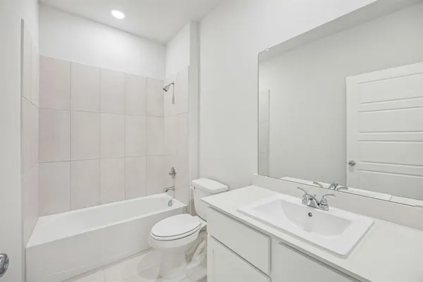 a bathroom with a toilet a sink and bathtub