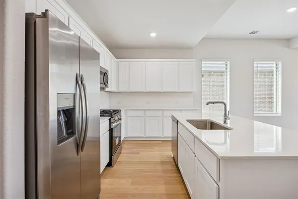 a kitchen with refrigerator a sink and dishwasher