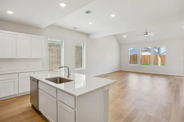 a kitchen with sink and refrigerator