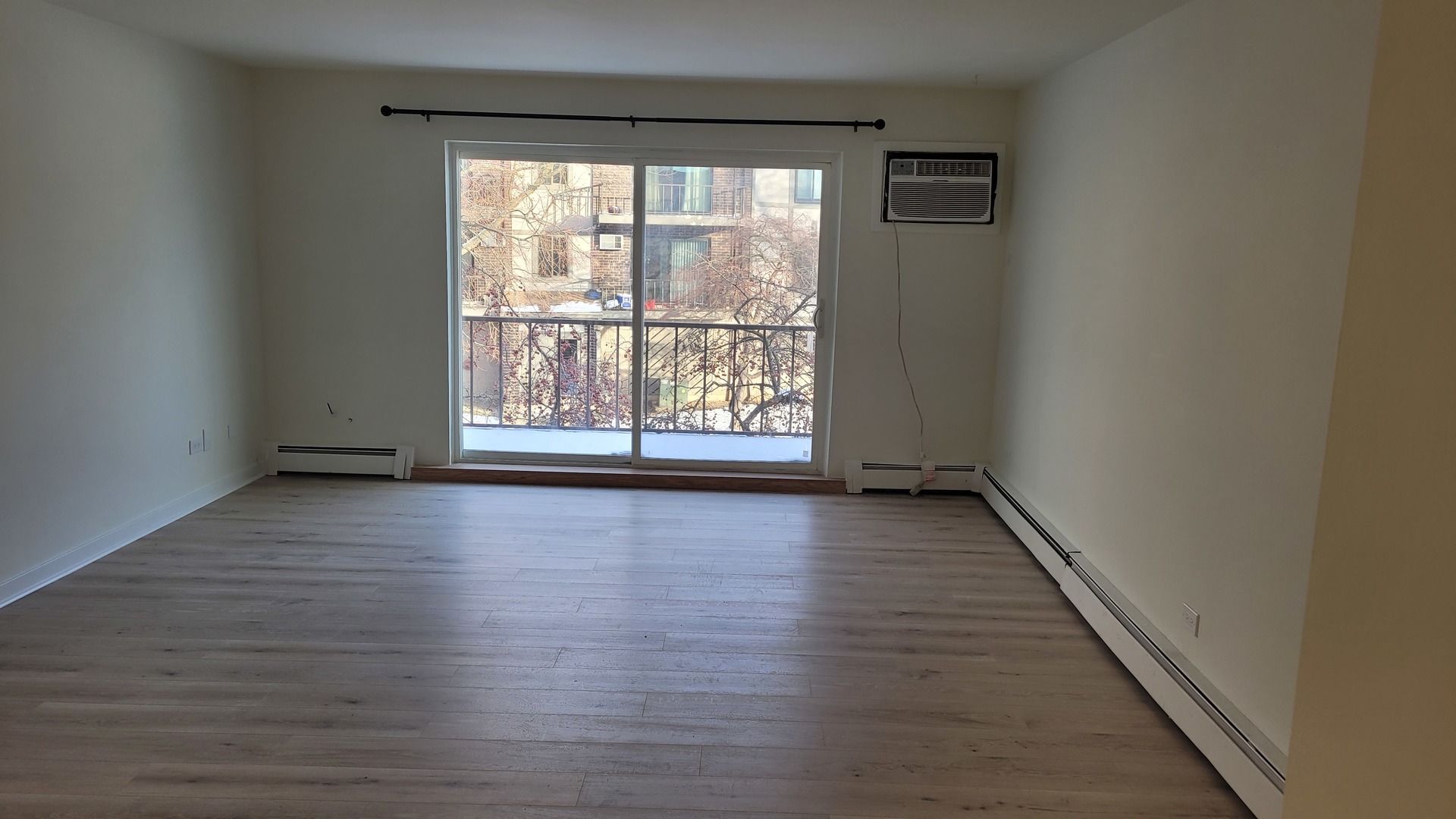 514 Kiowa Circle, Unit 204 Naperville, IL 60565 - Photo 4 of 8 wooden floor in an empty room with a window