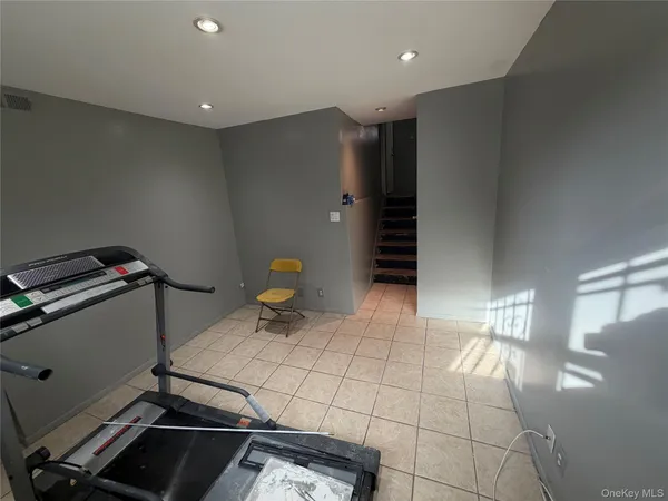 a room with gym equipment and a table