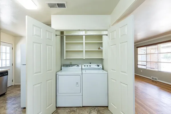 an empty room with windows and closet area