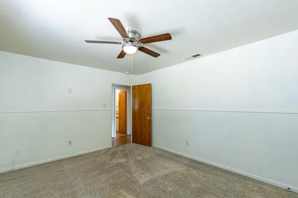 a view of a livingroom with a ceiling fan and window