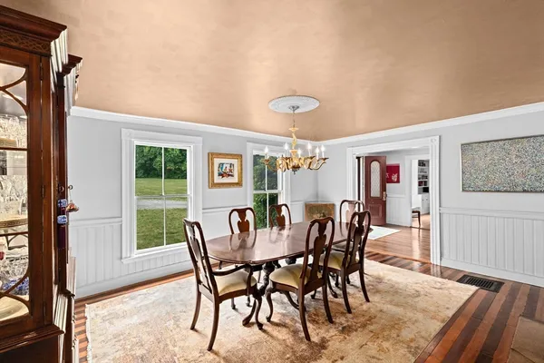 a view of a dining room with furniture window and wooden floor