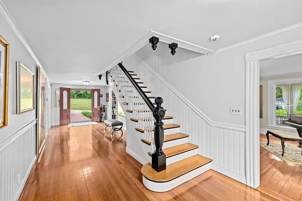a view of entryway and hall with wooden floor